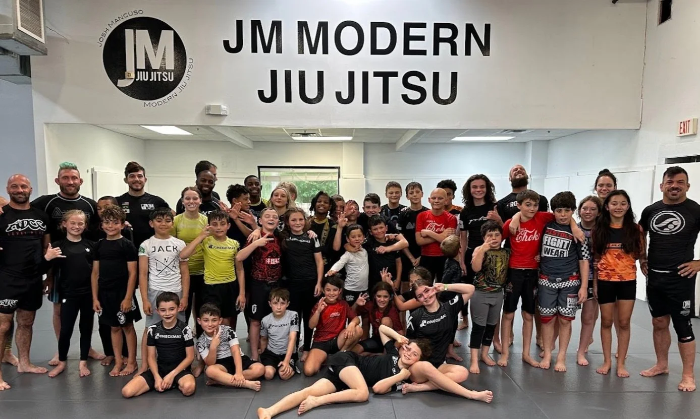 Students of every age lined up on the mats at JM Modern Jiu Jitsu